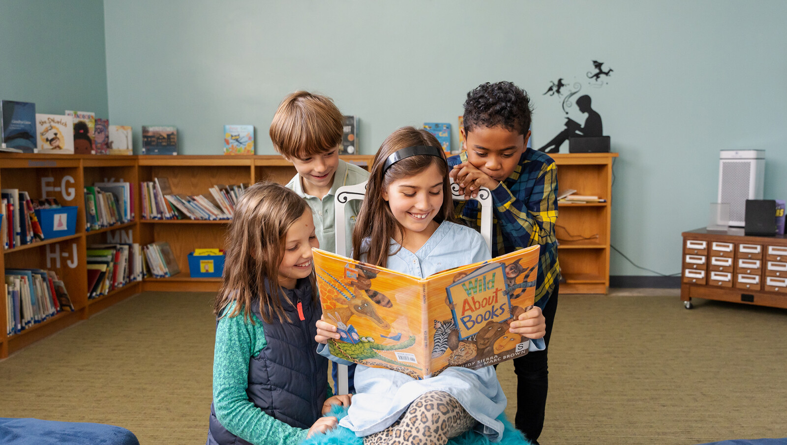 Trinity Christian School students reading a book together in the library